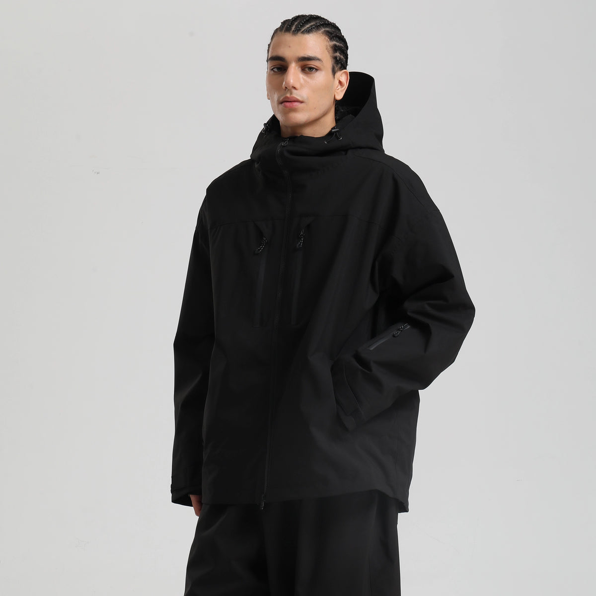 Core 2L Insulated Ski Jacket in black, model three-quarter view with hand in pocket and sleeve pocket