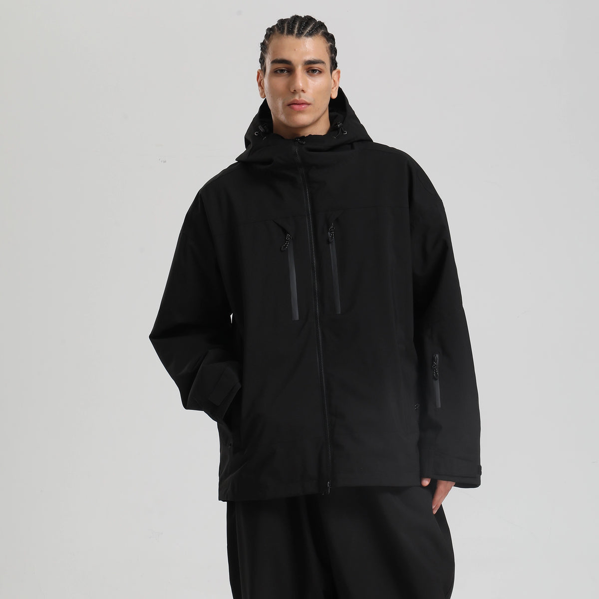 Core 2L Insulated Ski Jacket in black, model front view with hood up and ski pass pocket on sleeve