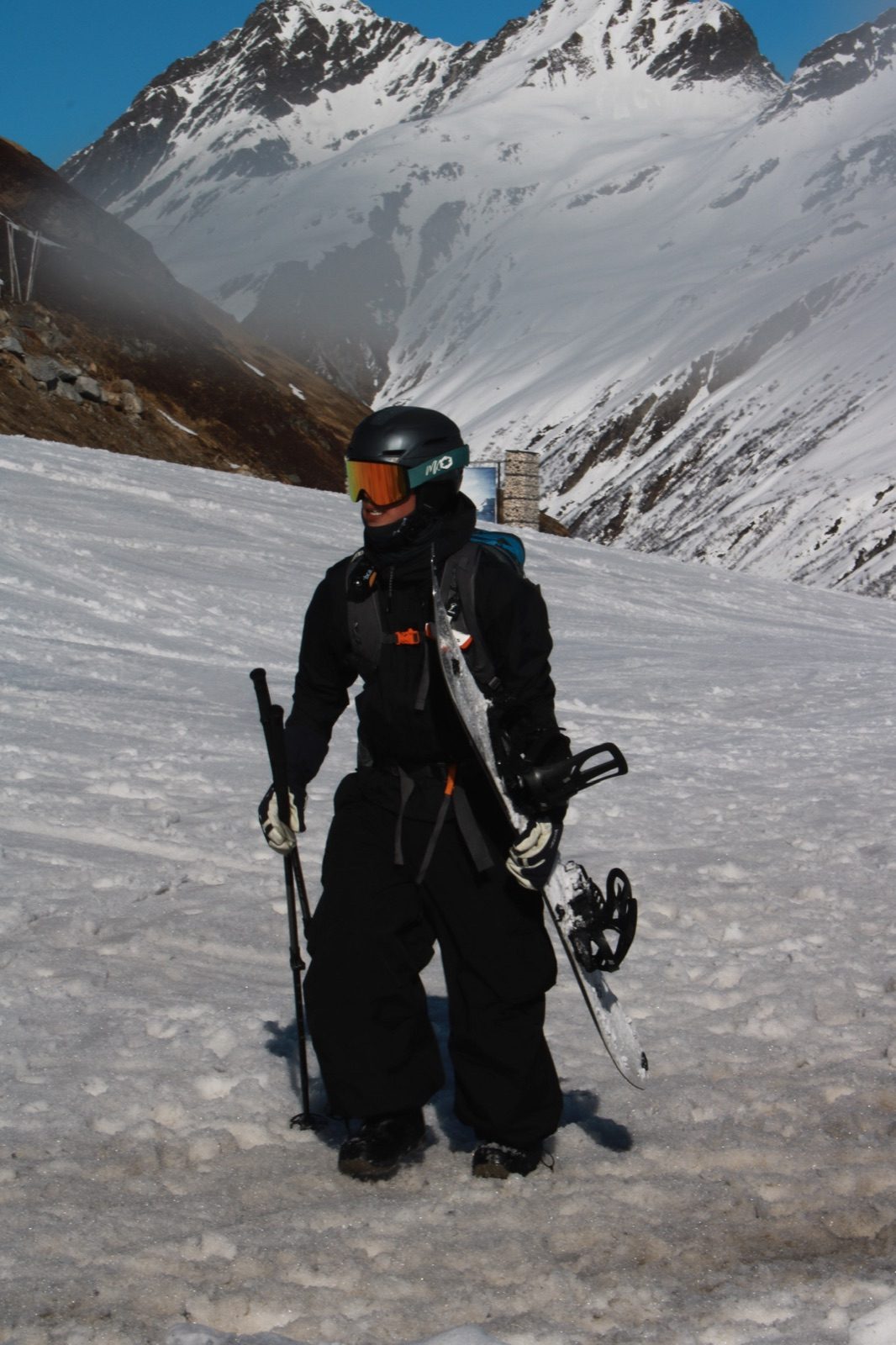 Rider in black Core set against alpine peaks